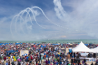 Planes performing maneuvers over North Avenue Beach with large crowd looking on